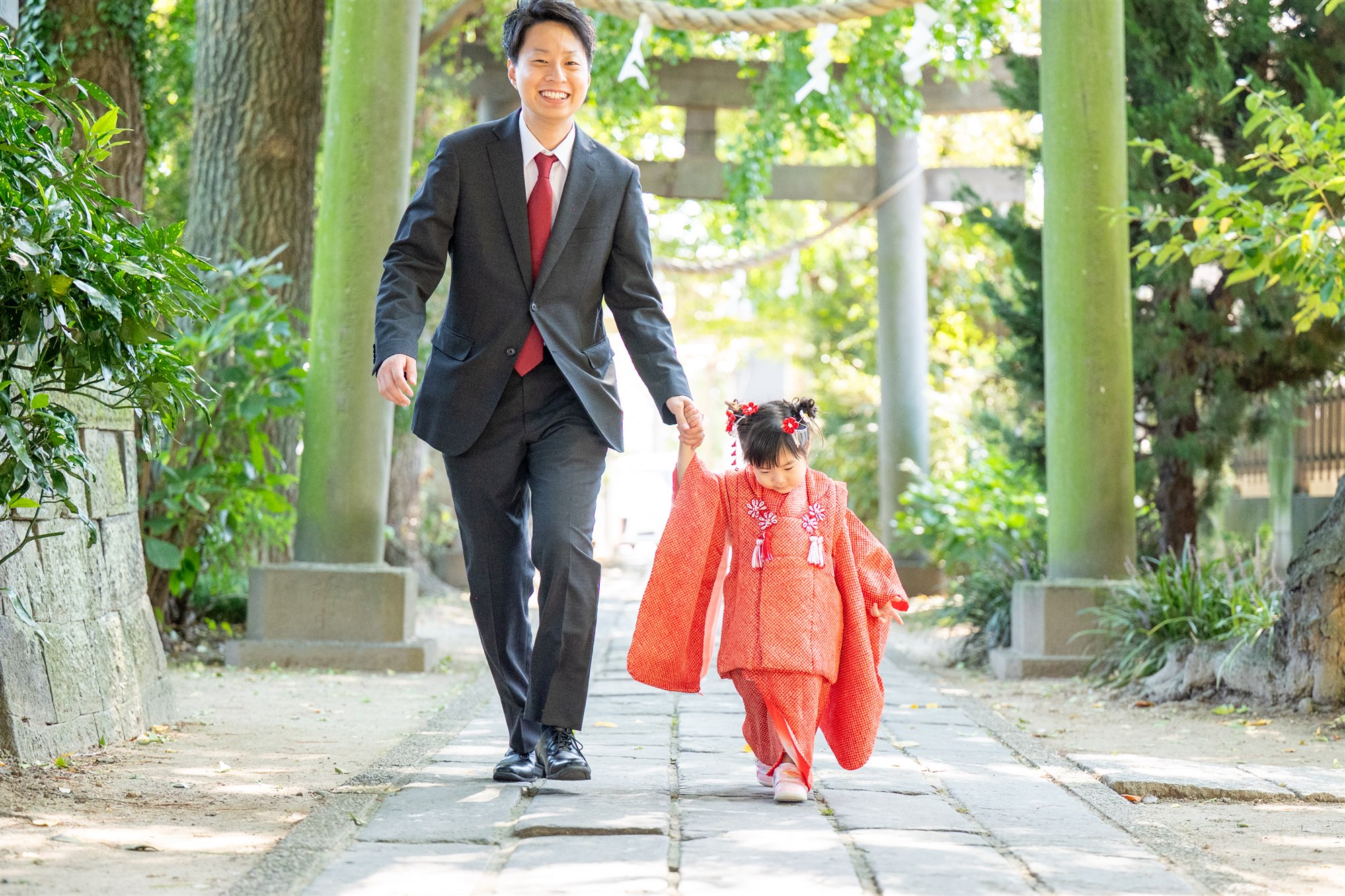 パパと手をつないで香取神社の参道を歩く七五三の女の子